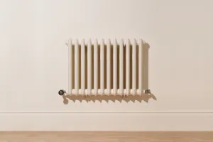 Wall-hung Emmeline II 670mm cast iron radiator in Farrow & Ball Dimity No. 2008 with Satin Nickel valves, above a skirting board and oak floor.