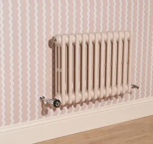 Plain wall-hung Mercury 3 column cast iron radiator in Farrow & Ball Scallop No. 311 with chrome valves, against pink wavy-striped wallpaper.