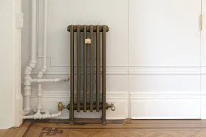 cast iron steam radiator in bespoke beaten brass finish