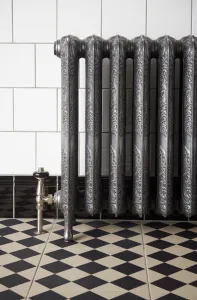 Ornate Rococo II cast iron radiator in Etch-Coated Polish on feet, with a nickel angled valve, white wall tiles and a black and cream chequered floor.