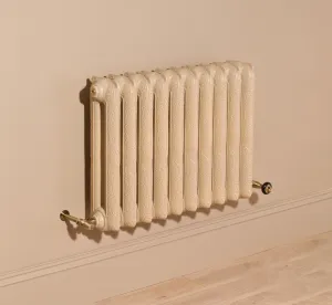 Ornate Rococo II 660mm cast iron radiator in Farrow & Ball Planter No. G5, wall-hung above a skirting board with brass valves and oak floor.