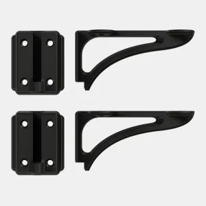 Two Atlas wall brackets in a matt black finish, each shown as a four-hole wall plate beside a curved cantilever arm, on a pale grey background.