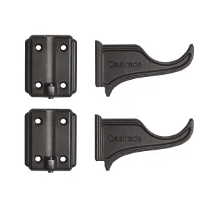 Two Atlas cast iron wall brackets in a dark finish, each a screw-holed wall plate beside a curved Castrads-embossed arm, on white.