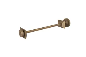 Whitworth wall stay in Natural Brass: a long threaded rod with square wall plates and round end caps, one with an embossed emblem, on white.