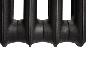 Close-up of the lower sections of an Emmeline I cast iron radiator in Matt Black, showing plain textured columns and joints on a white background.
