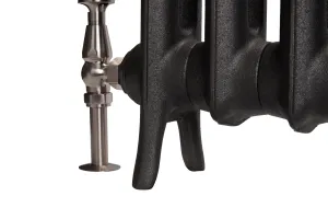 Close-up of the foot and lower sections of an Emmeline I cast iron radiator in Matt Black, with a satin nickel angled valve on a white background.