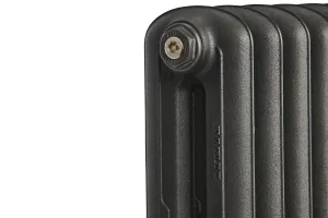 Close-up of the top corner of an Emmeline II cast iron radiator in Black Iron, showing its rounded columns, textured surface and end plug.