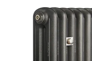 Close-up of the top corner of an Emmeline II cast iron radiator in Black Iron, with a hex bleed plug and a nickel wall stay between columns.