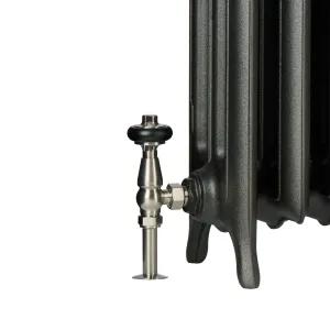 Close-up of the foot of an Emmeline III cast iron radiator in a dark metallic finish, with a brushed nickel thermostatic valve and black head.