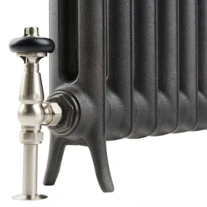 Close-up of the foot of an Emmeline I cast iron radiator in a dark textured finish, with a brushed nickel valve and black head.