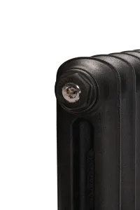 Close-up of the top corner of an Emmeline cast iron radiator in Matt Black, showing the Castrads-stamped end plug, chrome bleed valve and cast Emmeline name.