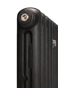 Close-up of the end of an Emmeline cast iron radiator in Matt Black, showing the Castrads-stamped bleed plug and embossed Emmeline lettering.