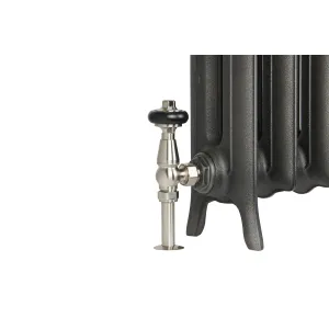 Close-up of the foot end of an Emmeline II cast iron radiator in Black Iron, fitted with a satin nickel angled valve with a black head.