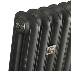 Close-up of the top corner of an Emmeline II cast iron radiator in Black Iron, showing the bleed valve plug and a brushed nickel stay on a white background.