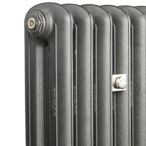 Close-up of the top corner of an Emmeline II cast iron radiator in Black Iron, showing rounded columns, a Castrads end plug and a nickel wall stay.