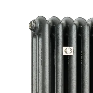 Close-up of the top corner of an Emmeline III cast iron radiator in a textured graphite grey finish, with a bleed valve and a square nickel plate.