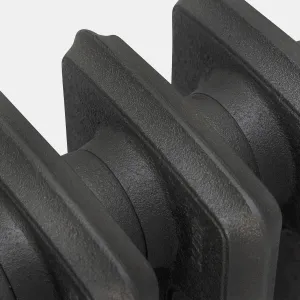 Close-up of plain cast iron radiator sections in Matt Black, showing the textured cast surface and the joints between columns.