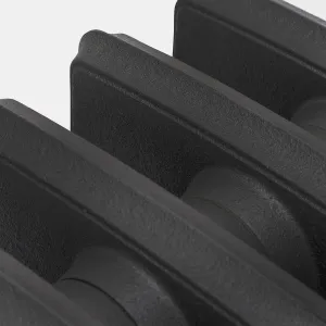 Close-up of the plain cast iron sections of a Grace radiator in Matt Black, showing the textured cast surface and joining nipples.