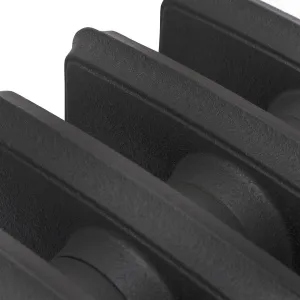 Close-up of the plain sections of a Grace 6 column cast iron radiator in a textured black finish, showing the joints between sections.