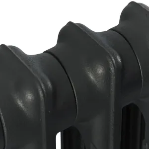 Close-up of the rounded tops of plain Mercury 2 Column cast iron radiator sections in Matt Black, showing the joins and cast texture.