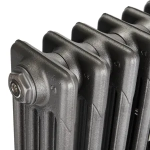 Close-up of the top corner of a plain Mercury 4 Column cast iron radiator in Black Iron, showing the sections and a chrome end plug, on white.