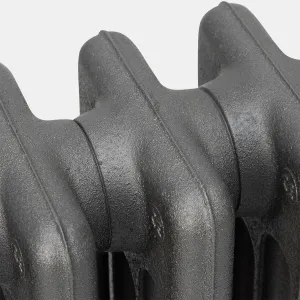 Close-up of the plain rounded sections of a Mercury cast iron radiator in a textured Black Iron finish, showing the joins between sections.