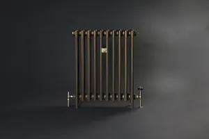 Plain Mercury 4 column cast iron radiator in Beaten Brass on feet, with angled and thermostatic valves, against a dark grey backdrop.