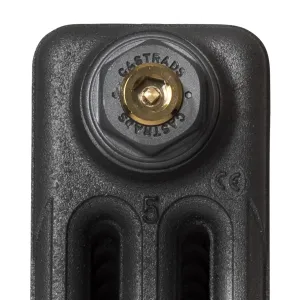 Close-up of the top of a plain Mercury cast iron radiator end section in a dark grey finish, with a brass bleed valve in a Castrads-stamped plug.