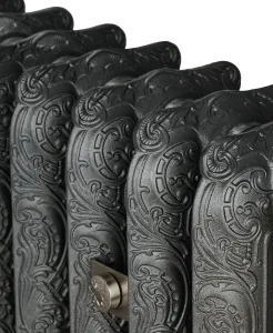 Close-up of ornate Rococo II cast iron radiator sections with scrolled relief in a dark iron finish and a satin nickel wall stay.