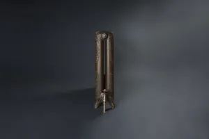 End view of an ornate Rococo II cast iron radiator on scrolled feet in a bronze finish, with a matching angled valve, against a dark grey backdrop.