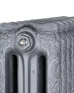 Close-up of the top corner of an ornate Rococo III cast iron radiator in Black Iron, showing scrollwork and a chrome Castrads bleed plug.