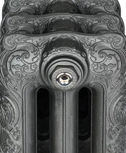 Close-up of the ornate scrolled top of a Rococo cast iron radiator in Black Iron, with a polished nickel air vent plug on the end section.