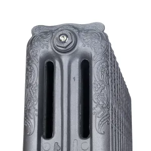 Close-up of the ornate scrolled end section of a Rococo three-column cast iron radiator in Black Iron, with a bleed valve plug on top.