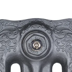 Close-up of the top of an ornate Rococo III cast iron radiator end section in Black Iron, with scrollwork and a Castrads-stamped plug.