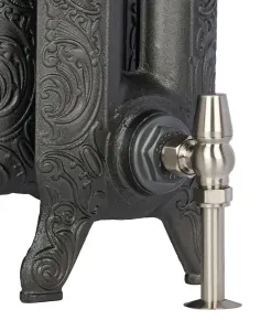 Close-up of the ornate scrolled foot of a Rococo II cast iron radiator in a dark iron finish, with a satin nickel angled valve and floor pipe shroud.