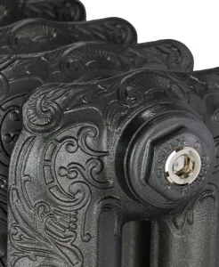 Close-up of an ornate Rococo II cast iron radiator in a dark metallic finish, showing scrolled castings and a Castrads end cap with nickel bleed valve.