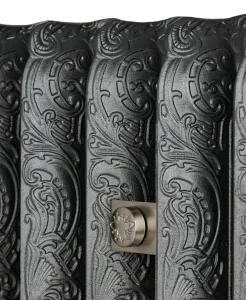 Close-up of ornate Rococo II cast iron radiator columns in Black Iron with scrolling relief and a satin nickel bee-motif fitting.