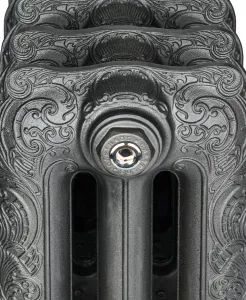 Close-up of the end section of an ornate Rococo cast iron radiator in a dark iron finish, with a chrome bleed valve in a Castrads-stamped plug.