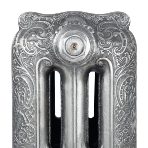 Close-up of the top of a Rococo III three-column cast iron radiator section with ornate scrollwork and a bleed valve, in Satin Polish.