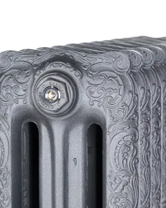 Close-up of the top of an ornate Rococo III cast iron radiator in Black Iron, with scrolled foliage relief and a Castrads-stamped bleed plug.
