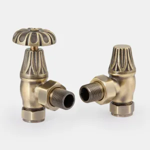 A pair of Chatsworth angled radiator valves in Antique Brass, one with an ornate fluted wheel head, the other with a lockshield cap.