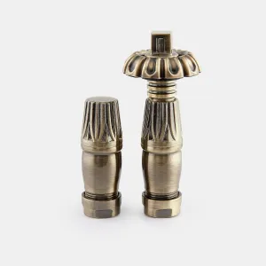 Chatsworth radiator valve pair in Antique Brass: a lockshield and a thermostatic valve with ornate fluted head, on a plain white background.
