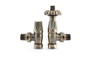 Pair of Chatsworth angled radiator valves in Antique Brass, a thermostatic head with fluted crown beside a lockshield, on white.