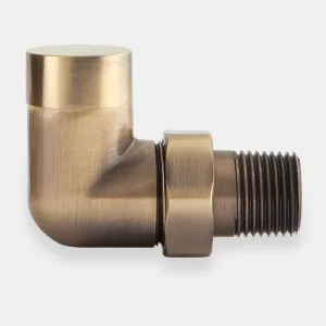 A Niva corner lockshield radiator valve in a brushed Antique Brass finish, with a flat round cap, hex union nut and threaded tail, on a grey background.
