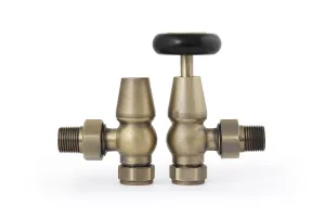 Pair of Windsor angled manual radiator valves in Natural Brass, one with a black wheel head and one lockshield cap, on a white background.