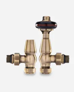 Windsor angled thermostatic radiator valve with a dark wooden-look head beside a matching lockshield, both in Antique Brass, on a plain background.