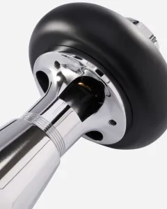 Close-up of a chrome Windsor radiator valve body with a black round head, ribbed collar and exposed brass spindle, on a white background.