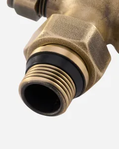 Close-up of the threaded tail and hexagonal union nut of a Windsor radiator valve in Natural Brass, with a black sealing ring.