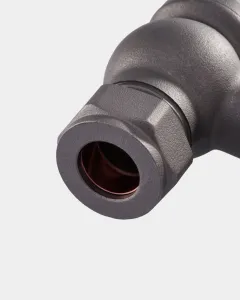 Close-up of a Windsor angled radiator valve in Natural Pewter, showing the hexagonal compression nut and copper olive inside, on a pale grey background.