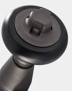 Close-up of a Windsor angled thermostatic radiator valve in Natural Pewter, showing the black head with its square spindle top, on a pale grey background.